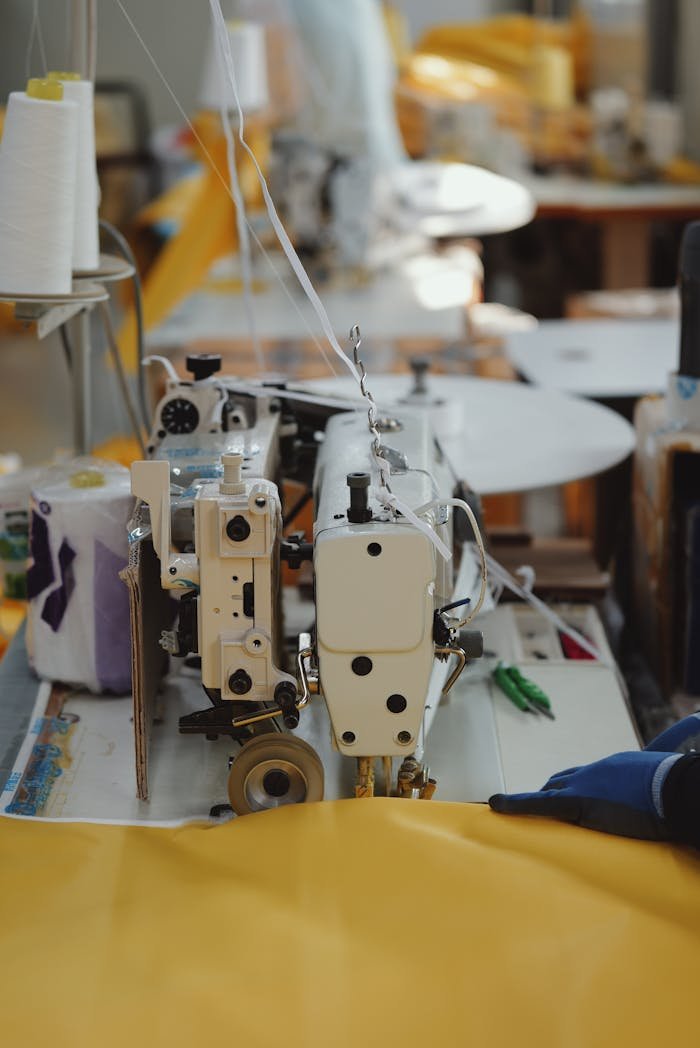 Detailed view of sewing machines in a textile workshop, highlighting industry and craftsmanship.